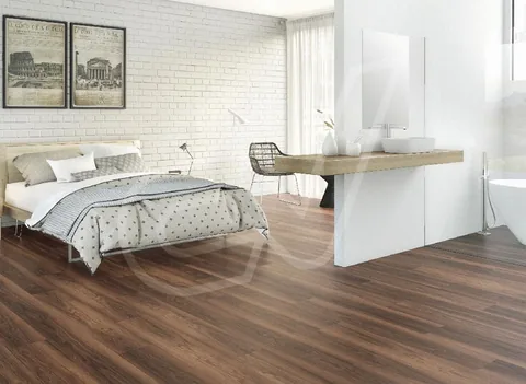 Suelo de madera oscura en un dormitorio con pared de ladrillo blanco