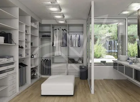 Vestidor abierto con módulos blancos y banqueta central